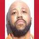 Man with a beard and serious expression, image from The Fostoria Free Press.