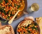Fresh homemade vegetable soup served with bread on a table.