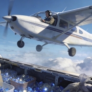 Fostoria News Small plane flying over clouds seen from inside a helicopter.