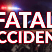 Headline about fatal accident with emergency lights in background.