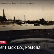 Fostoria News: Real-photo postcard of the Independent Tack Co. factory in Fostoria, Ohio, with smokestacks, a water tower and a round pond in the foreground