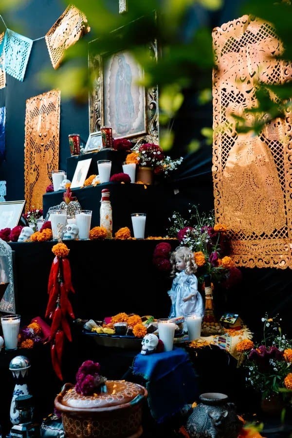 Fostoria News: A Day of the Dead ofrenda altar decorated with candles, papel picado and marigolds