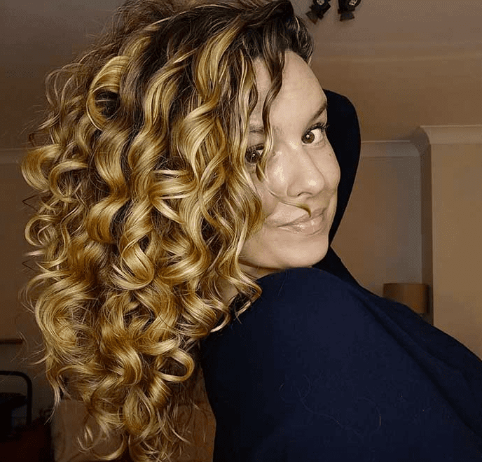 Type 2C hair with thick, well-defined S-shaped waves and volume that border on loose curls.