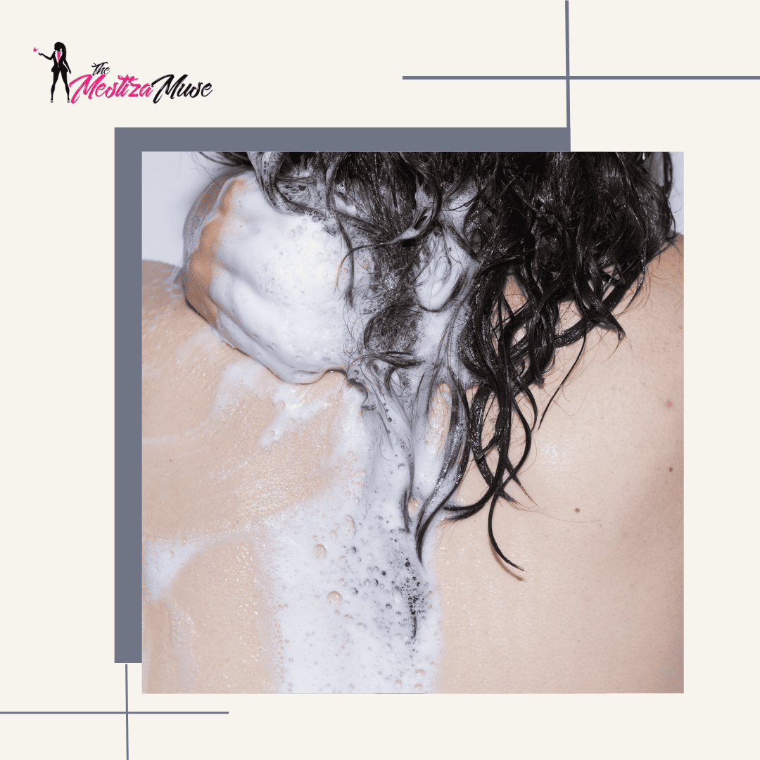Image of the back of a curly girl's hair with shampoo in it.