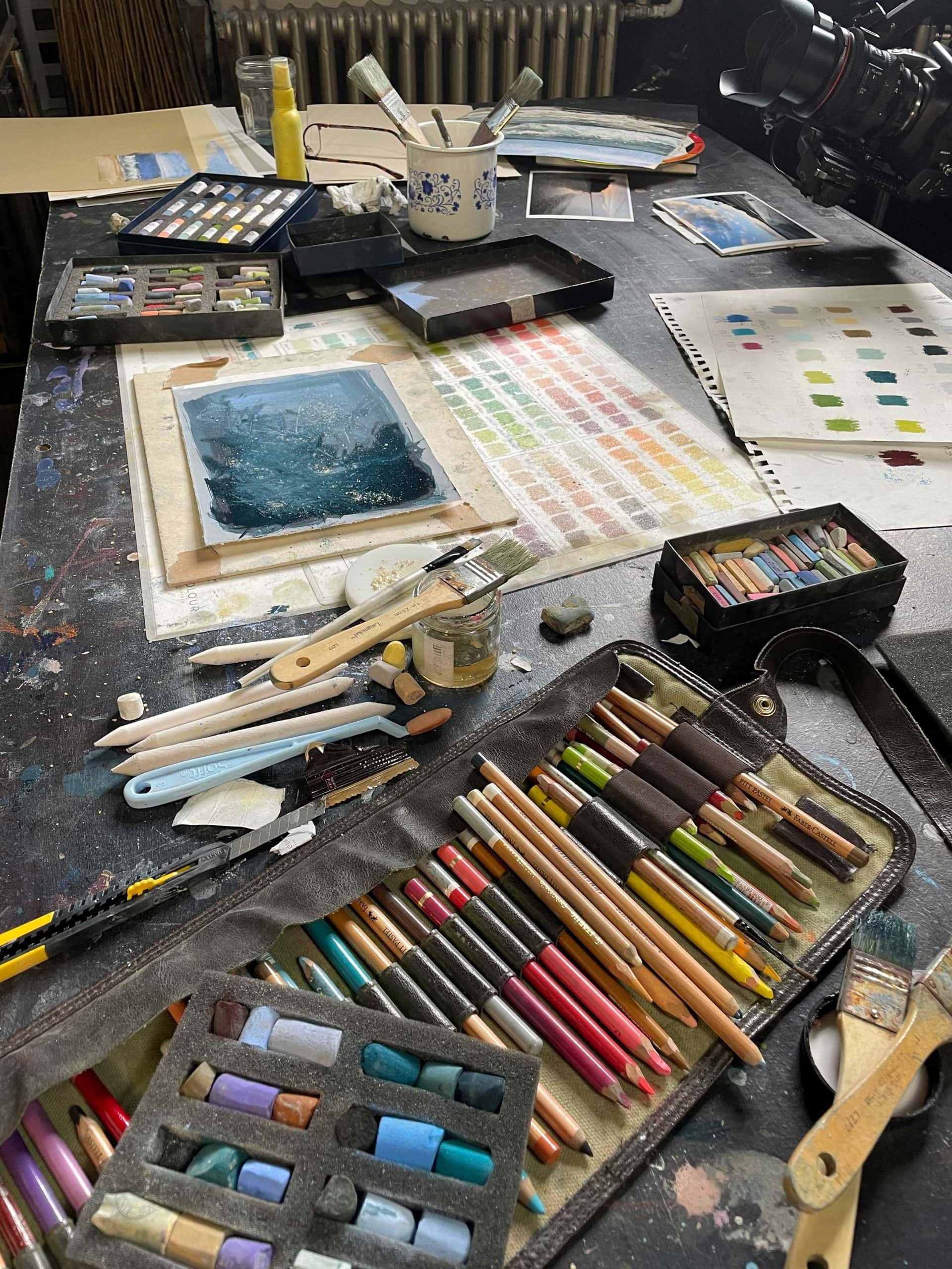 DreamStudio a photograph of an art studio with art equipment showing exploration.