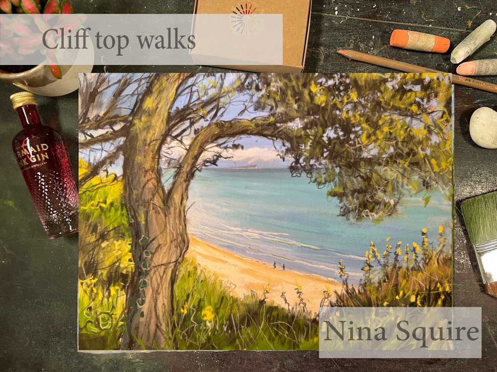 Pastel painting of a cliff top view with trees and beach by Nina Squire.