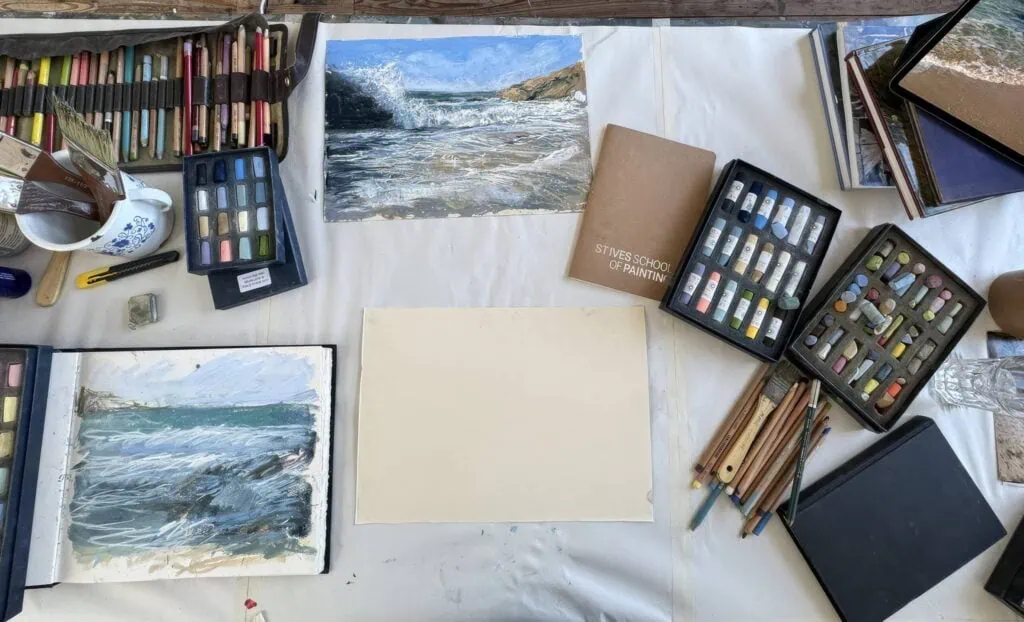 Artist Nina Squire's studio with soft pastels and landscape sketches.