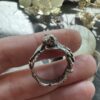 Green amethyst claw ring held in hand to show its full band and stone setting