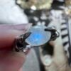 Blue flash in a rainbow moonstone held by sterling silver claws, US ring size 7