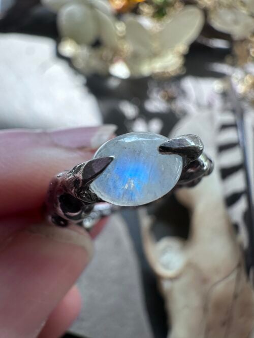 Blue flash in a rainbow moonstone held by sterling silver claws, US ring size 7 Blue flash in a rainbow moonstone held by sterling silver claws, US ring size 7