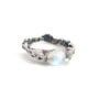 Rainbow moonstone claw-set sterling silver ring shown from the front on a white background