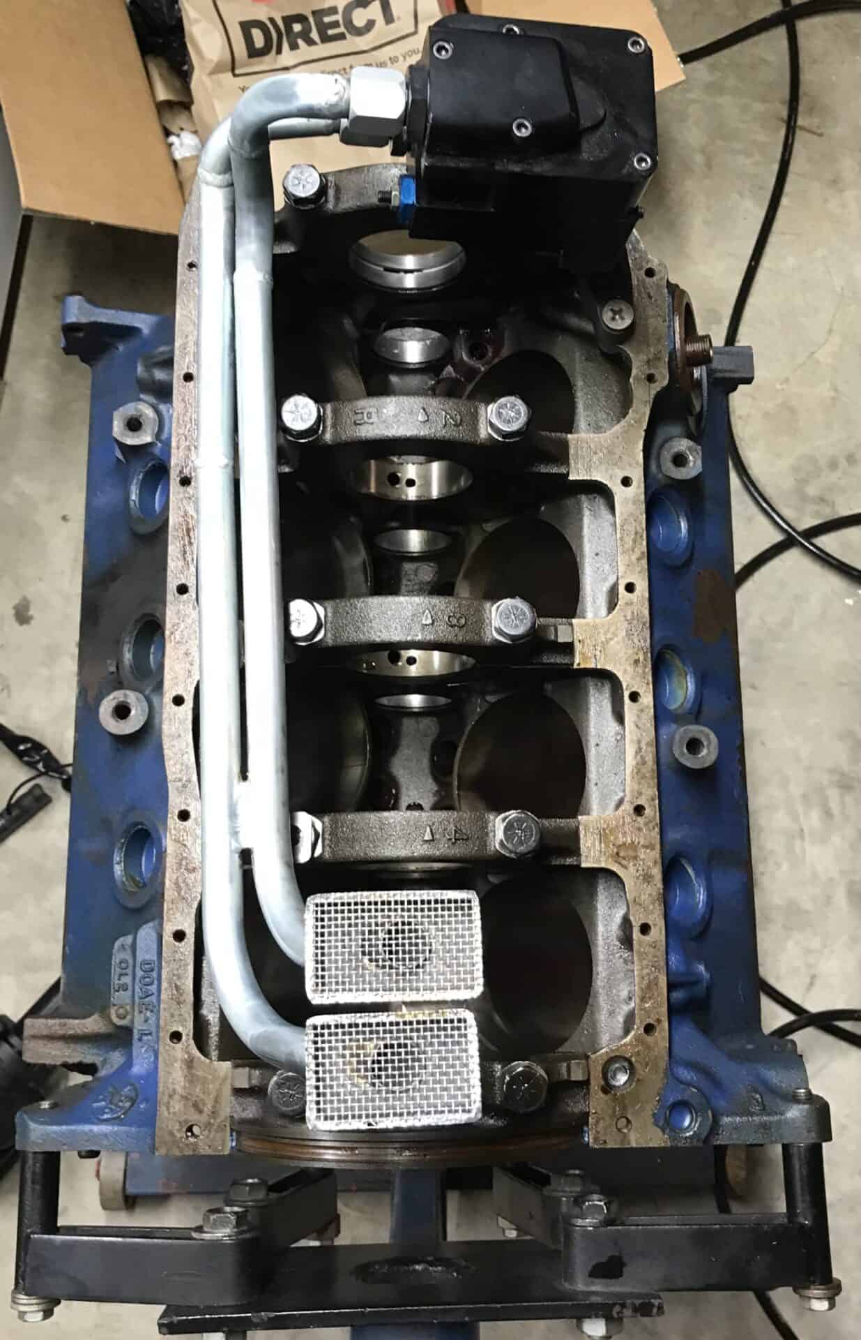 Valve train engine components on a workbench, part of custom automotive performance modification.