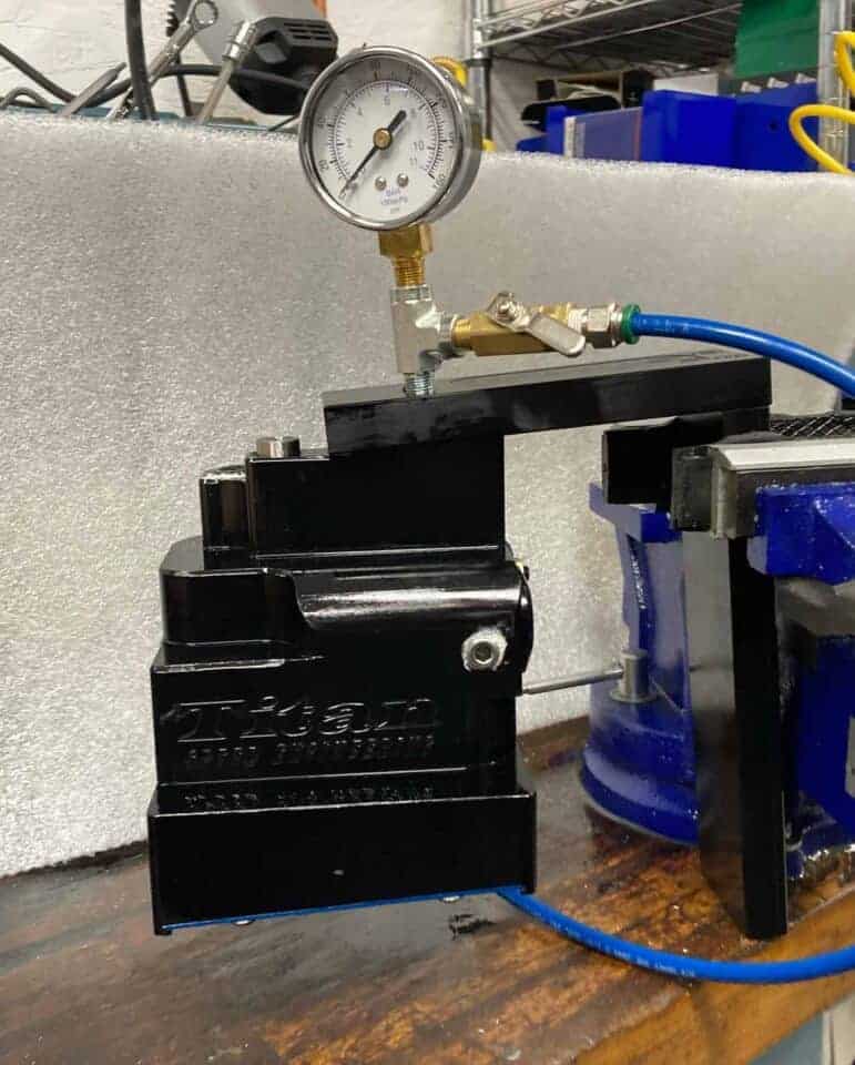 Air pressure regulator and gauge for racing or automotive applications, showcasing precision components used in Titan Speed Engineering projects.