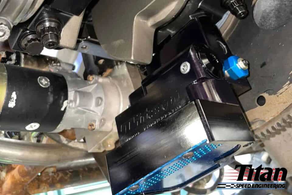 High-performance engine control module installed on a racing engine for Titan Speed Engineering, optimizing power and reliability for motorsports applications.