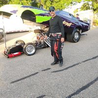 Blue drag racing car with black accents and safety gear, racing vehicle, high-performance sports car, Titan Speed Engineering.