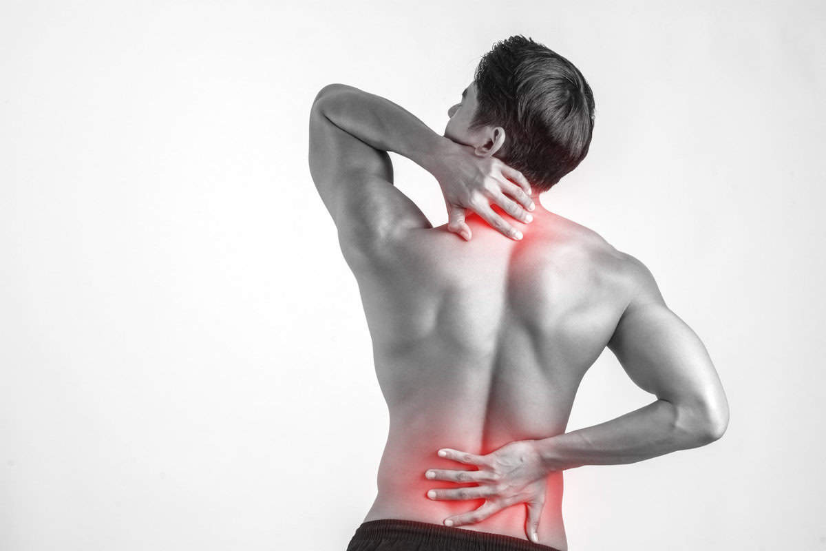 Man receiving a back and neck massage for pain relief at Tonic Day Spa.