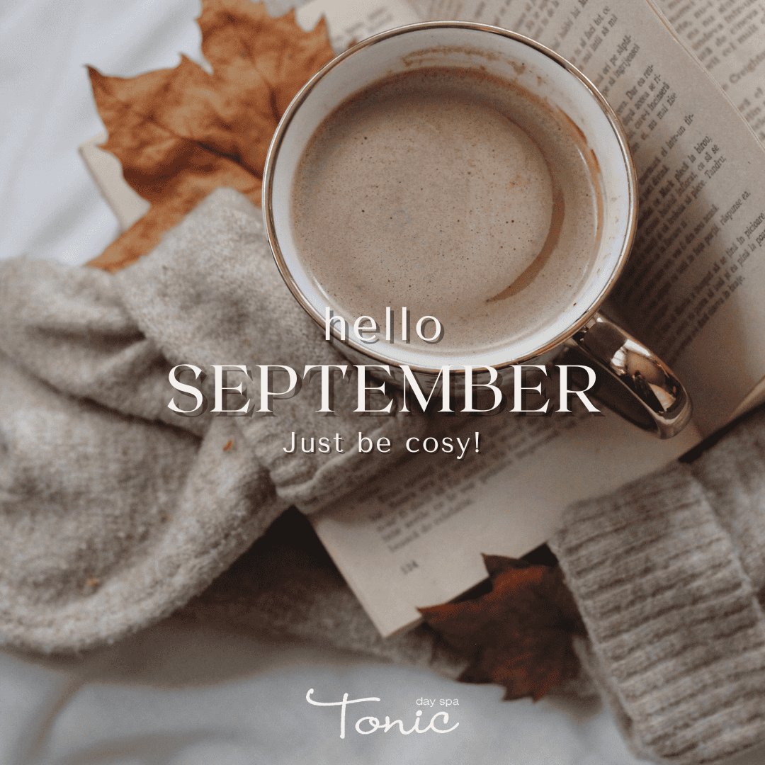 Cozy coffee cup with autumn leaves and newspaper, perfect for September relaxation.