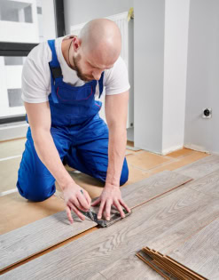 Professional flooring installer Tony Tadros laying hardwood floors.