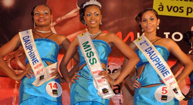 Trois jeunes femmes en robes bleues avec sashes de Miss et Dauphine.