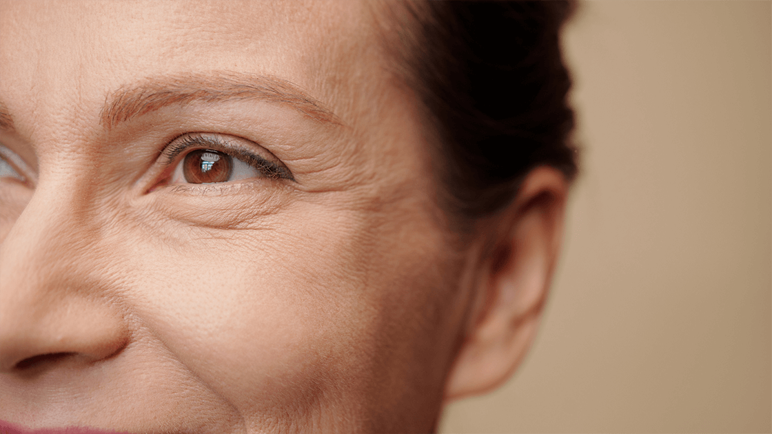 Smiling woman highlighting eye health during an eye exam, the perfect opportunity to inquire with your eye doctor, ophthalmologist, or optometrist near you about LASIK surgery and advanced vision care.