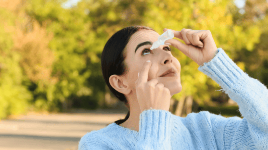 Woman applying eye drops for dry eyes before a LASIK consultation in Billings, MT