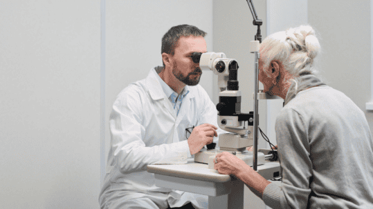 Eye doctor using a slit lamp to examine an older patient for prediabetes eye changes in Billings, MT