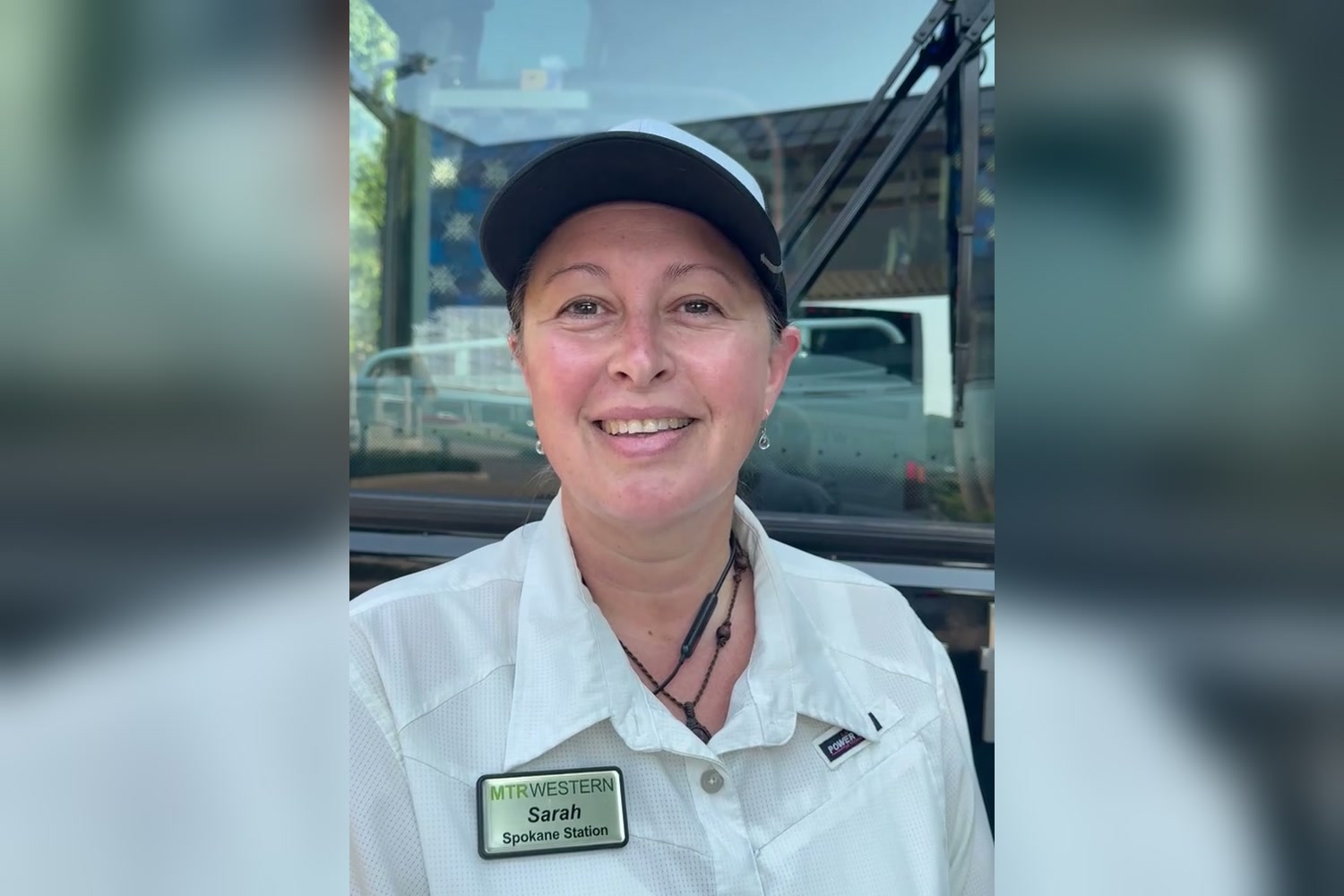 Sarah, a professional motor coach operator for MTR Western, smiling in front of her motor coach
