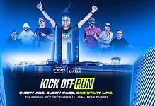 Group of diverse runners celebrating at the start line of the Triathlon Insight Kick Off Run event in Lusail, Qatar, with city skyline background.