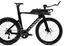 Black triathlon bike with aerodynamic design, carbon frame, and advanced components, ideal for competitive triathlon training and racing.