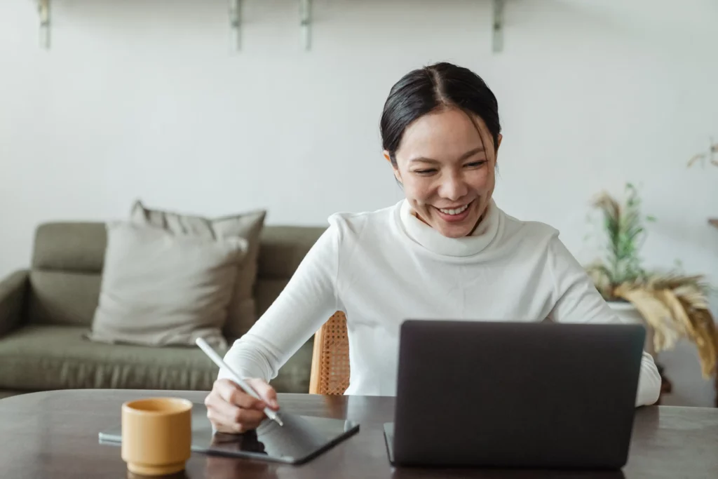 woman working at home and having videocall on laptop