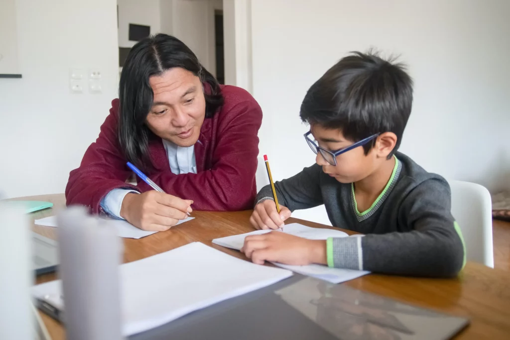 a tutor teaching a boy