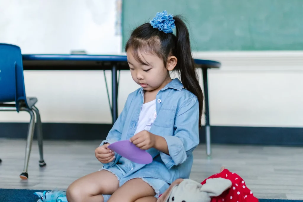 girl playing with toys on school