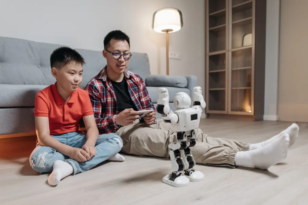 a man showing kid how to control a robot toy