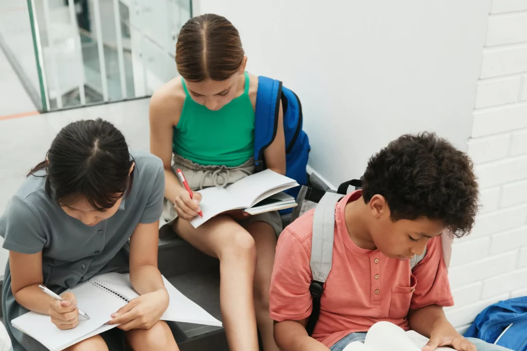 students sitting on the stairs while reading