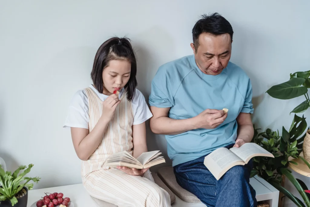father and daughter sitting on a bench