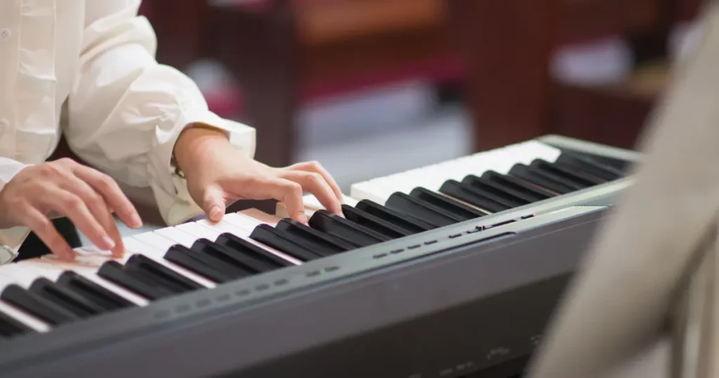 a person playing the piano in a church | tuitioncentre SG