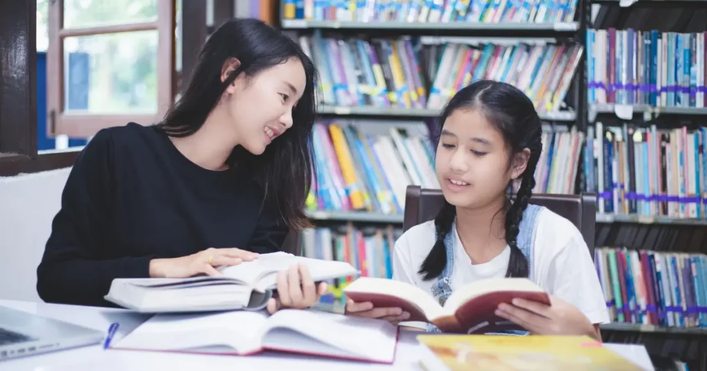 A mother and daughter studying in a library | tuitioncentre sg