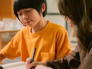 a woman and a young boy working on a laptop | tuitioncentre sg