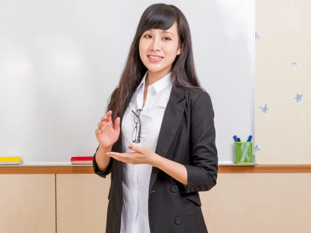 how much is an english tutor in Singapore? a person in a business suit standing in front of a whiteboard | tuitioncentre sg