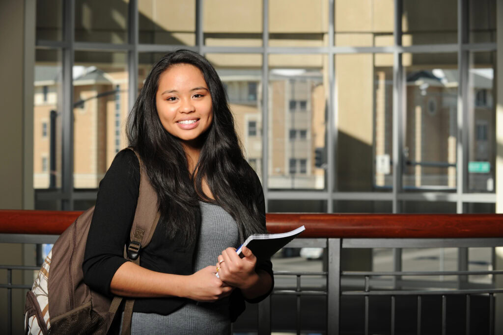 young asian student holding book | Tuition Centre