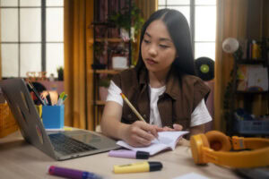 student writing in notebook | Tuition Centre SG