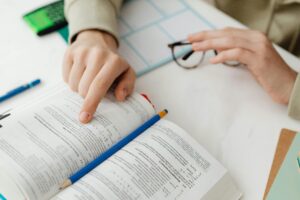 Person Reading A Math Book and Studying | Tuition Centre SG
