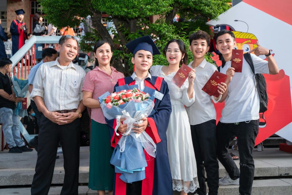 Happy Family Posing with Son After Graduation | Tuition Centre SG