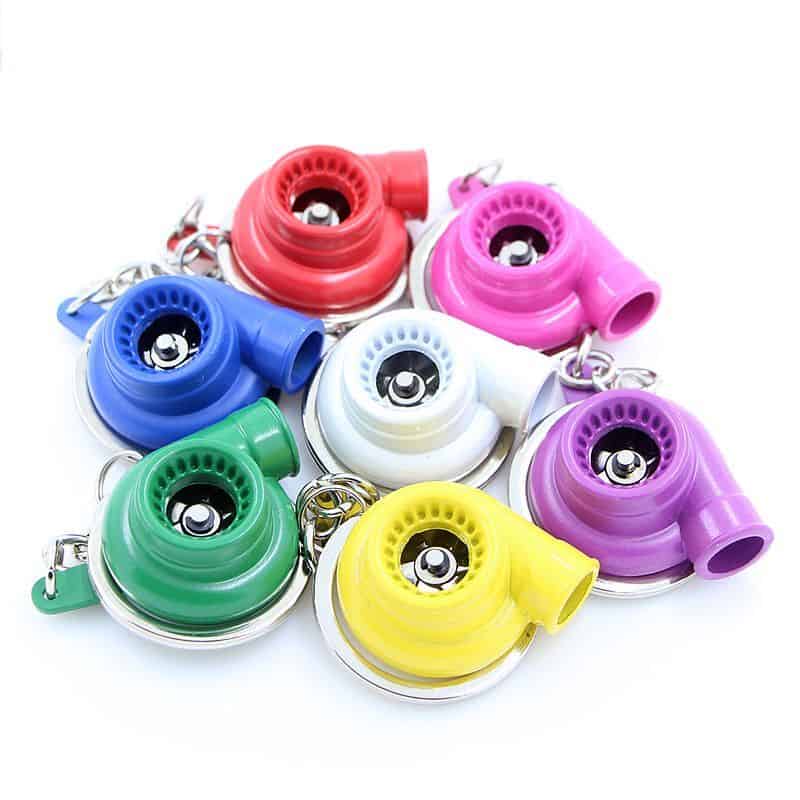 A group of spinning turbo keychains in various colors including red, blue, white, green, yellow, and purple.
