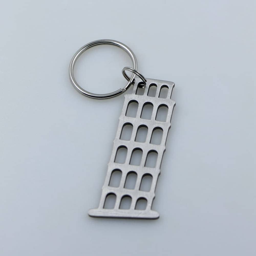 Metal car part keychain with a sleek industrial design, perfect for car enthusiasts.
