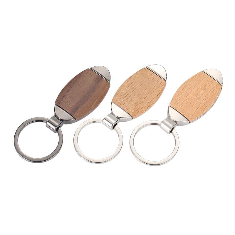A custom wood and metal keychain with an oval wood piece, a silver metal frame, and a key ring.