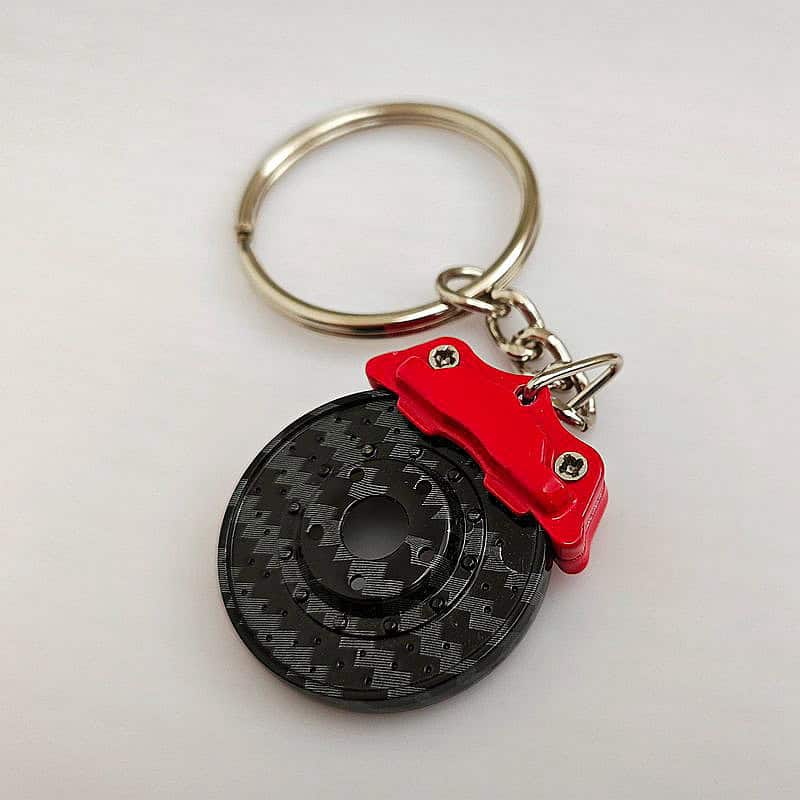 Custom racing brake caliper keychain with carbon fiber texture finish
