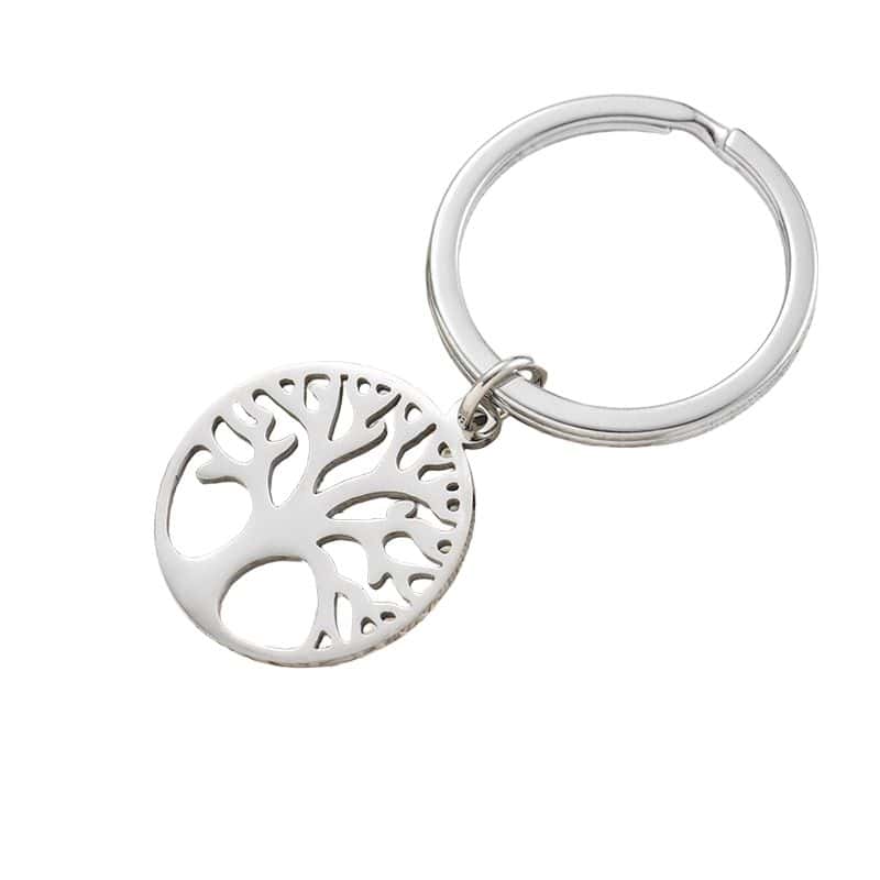 A round metal keychain with a cutout Tree of Life design and a silver key ring.