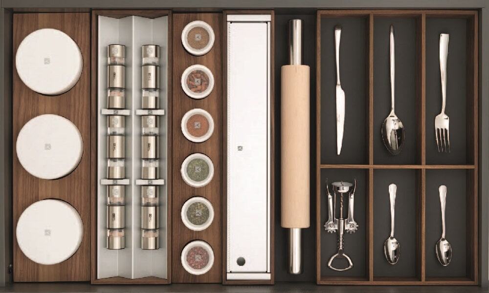 Kitchen utensil drawer organizer with cutlery, spices, and storage compartments.
