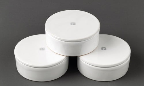 Set of three sleek white circular storage containers for urban home organization.